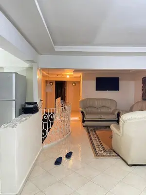 a living room with a couch and a tv at Maison in Mohammedia