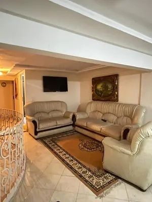 a living room with couches and a flat screen tv at Maison in Mohammedia
