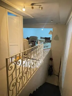 a staircase leading up to a living room with a couch at Maison in Mohammedia