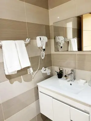 a bathroom with a white sink and a mirror at Ocean view & sunset in the heart of Rabat 2 in Rabat