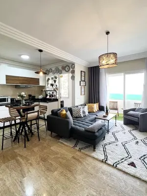 a living room with a couch and a table at Ocean view & sunset in the heart of Rabat 2 in Rabat