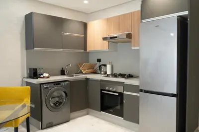 a kitchen with a washing machine and a washer at Prime location unmatched comfort in Casablanca
