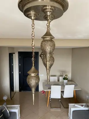 a large chandelier in a dining room with a table at Dar Bouazza piscine Bab Rayan in Casablanca