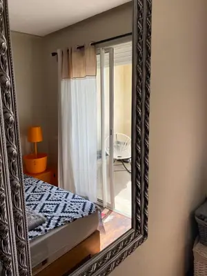 a mirror on a wall with a bed in a room at Dar Bouazza piscine Bab Rayan in Casablanca