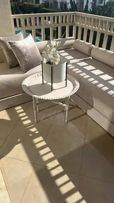 a white coffee table sitting on top of a balcony at Dar Bouazza piscine Bab Rayan in Casablanca