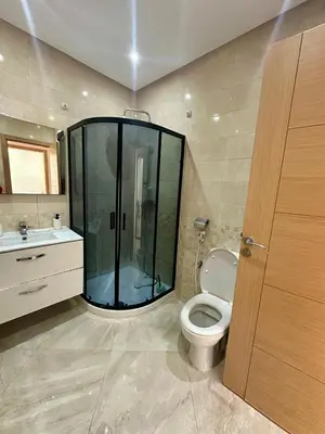 a bathroom with a glass shower and a toilet at Les Jardins de Bouznika Premium - Votre espace familial in Bouznika