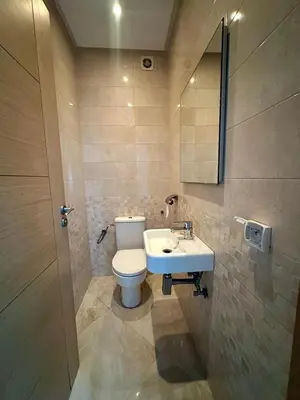 a bathroom with a toilet and a sink at Les Jardins de Bouznika Premium - Votre espace familial in Bouznika