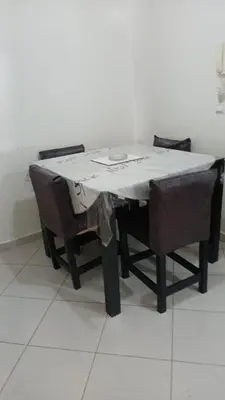 a table with a table cloth on it with two chairs at Bienvenue à Casablanca centre idéal pro ou famille in Casablanca
