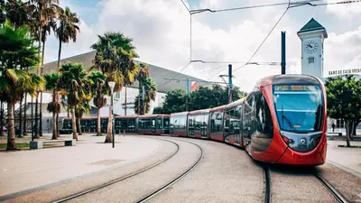 a red train on the tracks with a clock tower at Bienvenue à Casablanca centre idéal pro ou famille in Casablanca