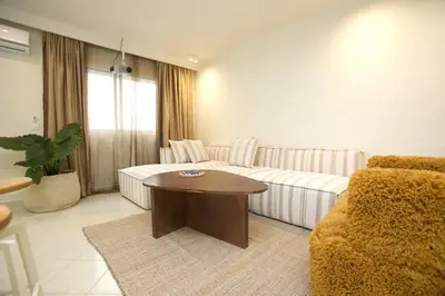 a living room with a couch and a table at Cozy apartment 5 minutes from Casa Voyageurs in Casablanca