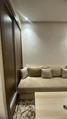 a couch sitting in a room with a window at Appartement meublé a sidi rahal in Sidi Rahal