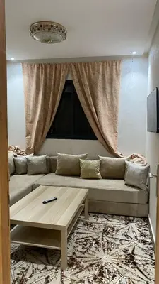 a living room with a couch and a coffee table at Appartement meublé a sidi rahal in Sidi Rahal