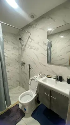 a bathroom with a toilet and a sink and a shower at Appartement meublé a sidi rahal in Sidi Rahal