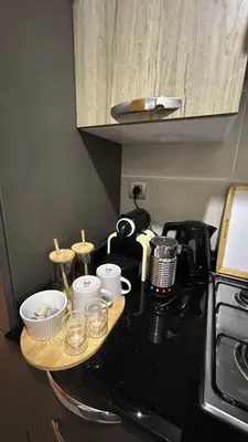 a kitchen counter with a coffee maker and cups on it at Modern and cozy accommodation in Rabat in Rabat