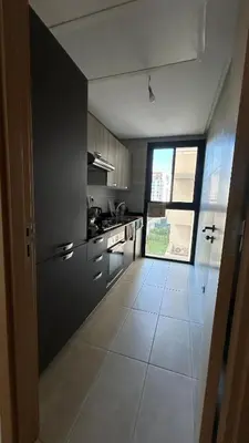 a kitchen with a large tile floor and a window at Modern and cozy accommodation in Rabat in Rabat