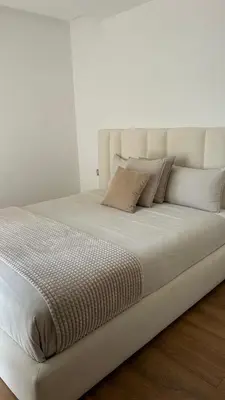 a large white bed with white sheets and pillows at Modern and cozy accommodation in Rabat in Rabat
