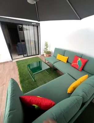 a living room with a blue couch with colorful pillows at Great for families and couples in Casablanca