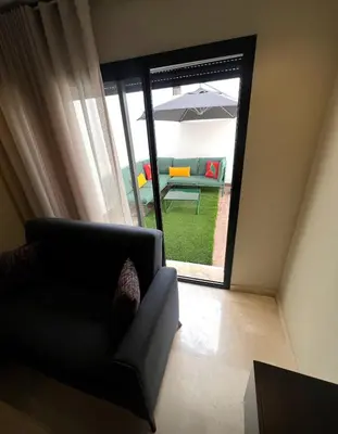 a living room with a couch and an umbrella at Great for families and couples in Casablanca