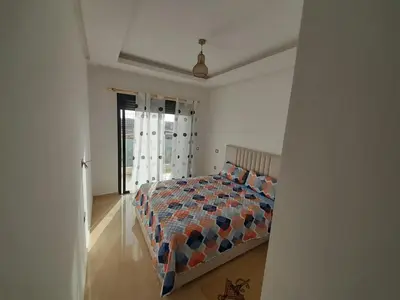 a bedroom with a bed and a window at Le passage inoubliable in Bouznika