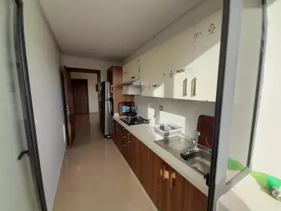 a small kitchen with a sink and a refrigerator at Le passage inoubliable in Bouznika