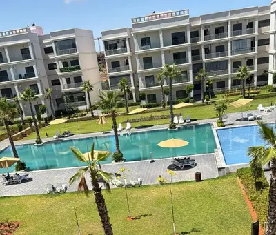 a large apartment building with a large swimming pool at Le passage inoubliable in Bouznika