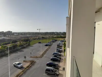 a row of cars parked in a parking lot at Le passage inoubliable in Bouznika