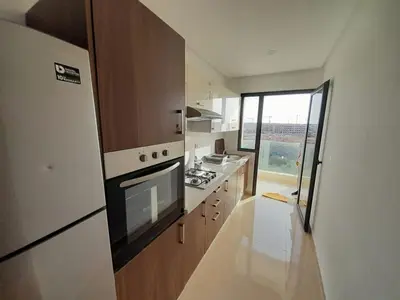 a small kitchen with a stove and a refrigerator at Le passage inoubliable in Bouznika