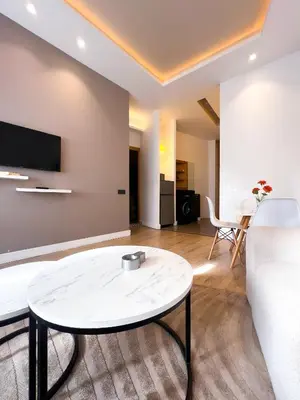 a living room with a white couch and a table at appartement Gautier in Casablanca