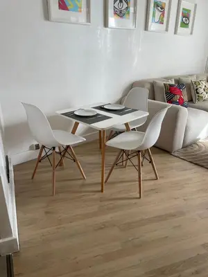 a table and chairs in a living room with a couch at appartement Gautier in Casablanca