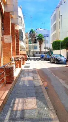 a street with cars parked on the side of a building at appartement Gautier in Casablanca