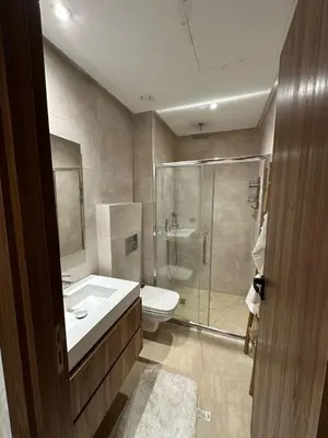 a bathroom with a shower and a sink and a toilet at Beautiful apartment in Tadart in Casablanca