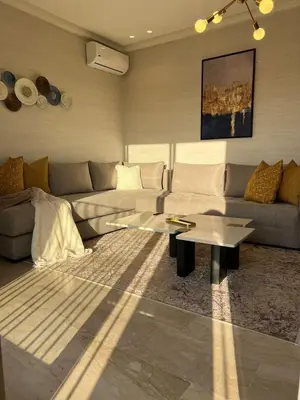a living room with a couch and a coffee table at Beautiful apartment in Tadart in Casablanca