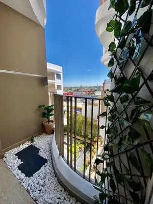 a balcony with a view of a building at Très beau appartement a tadart au centre de casablanca in Casablanca