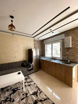 a kitchen with a couch and a refrigerator at Riad sultan in Casablanca