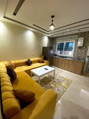 a living room with a yellow couch and a table at Riad sultan in Casablanca