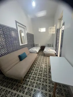 a living room with a couch and a table at Maison traditionnelle spacieuse in Rabat
