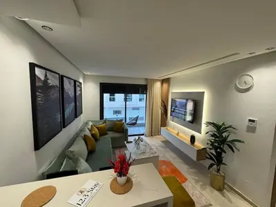 a living room with a couch and a table at Escale Confortable pour un Séjour Inoubliable in Maarif