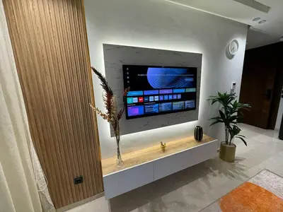 a living room with a flat screen tv on a wall at Escale Confortable pour un Séjour Inoubliable in Maarif