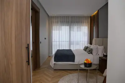 a bedroom with a bed and a table with fruit on it at HSuites Casablanca, Suite H Prime, Elegant one bedroom apartment in Casablanca