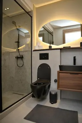 a bathroom with a black toilet and a shower at HSuites Casablanca, Suite H Prime, Elegant one bedroom apartment in Casablanca