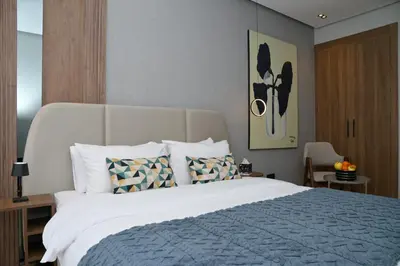 a bedroom with a large white bed with pillows at HSuites Casablanca, Suite H Prime, Elegant one bedroom apartment in Casablanca
