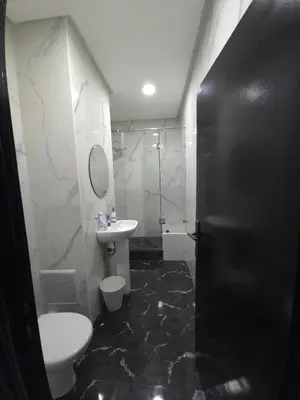 a bathroom with a toilet and a sink and a shower at Faridi house in Casablanca