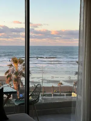 a view of the beach from a hotel room window at Panoramic ocean view appartement in Casablanca