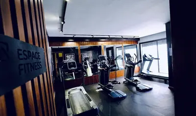 a gym with treadmills and ellipticals in a room at Apartment with GYM ! Private parking in Casablanca