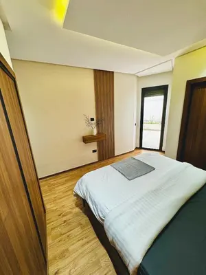 a bedroom with a large bed in a room at Apartment with GYM ! Private parking in Casablanca