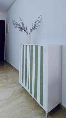 a white cabinet with a plant on top of it at Apartment with GYM ! Private parking in Casablanca