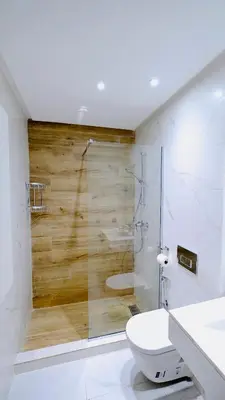 a bathroom with a toilet and a glass shower at Apartment with GYM ! Private parking in Casablanca