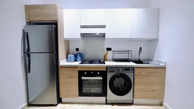a kitchen with a refrigerator and a dishwasher at Apartment with GYM ! Private parking in Casablanca