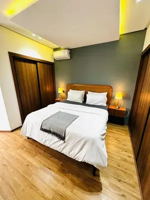 a bedroom with a large bed with white sheets and pillows at Apartment with GYM ! Private parking in Casablanca