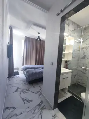 a bathroom with a bed and a sink and a mirror at Wafa in Casablanca
